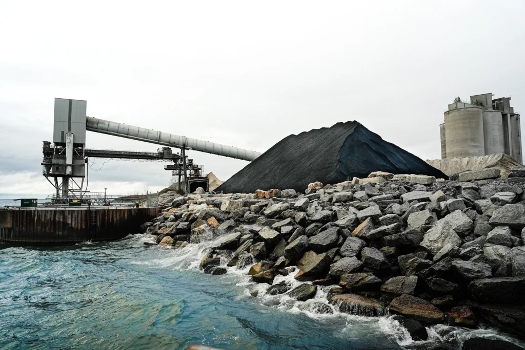 Cement Sustainability Commitments - Bowmanville lakefront dock with a rock breakwall, conveyor, stockpile and silo