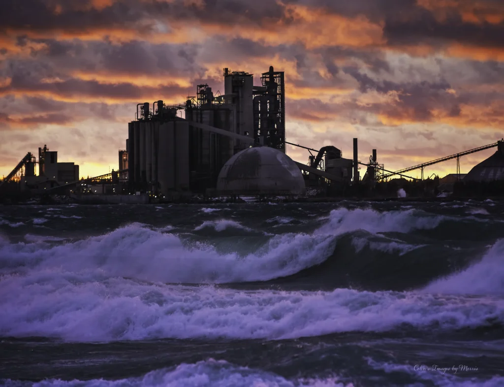 Charlevoix Cement Plant - plant silhouetted against a stormy sunset over Lake Michigan waves