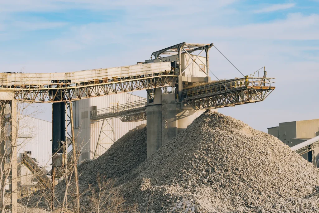 Cement Supplier - crushing plant conveyor above a stockpile of crushed stone