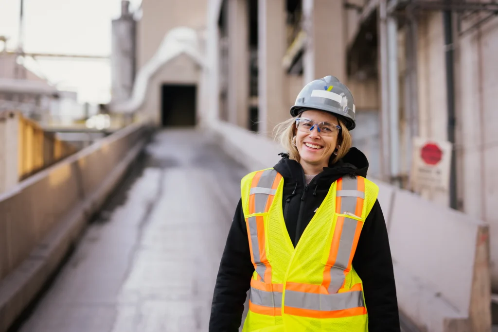 Cement Supplier - smiling team member in a hard hat and hi-vis vest in a plant corridor