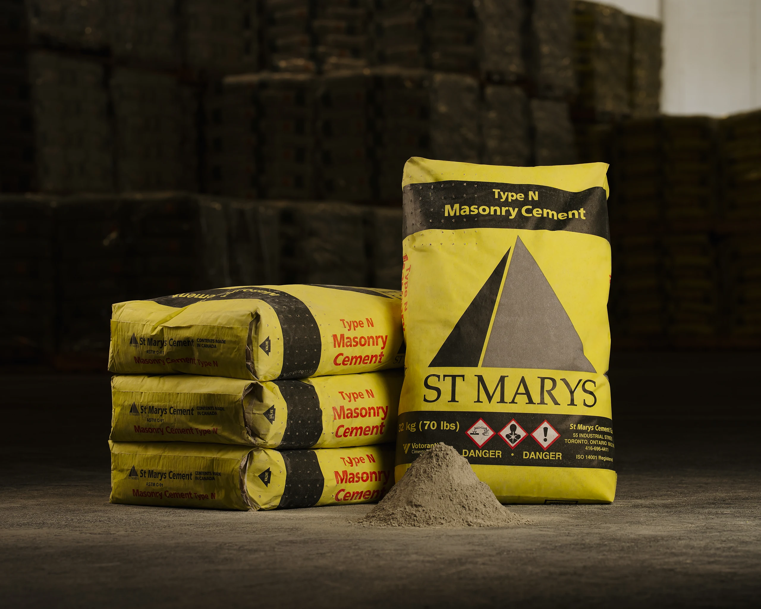 Type N Masonry Cement - yellow St Marys bags stacked beside a pile of cement powder