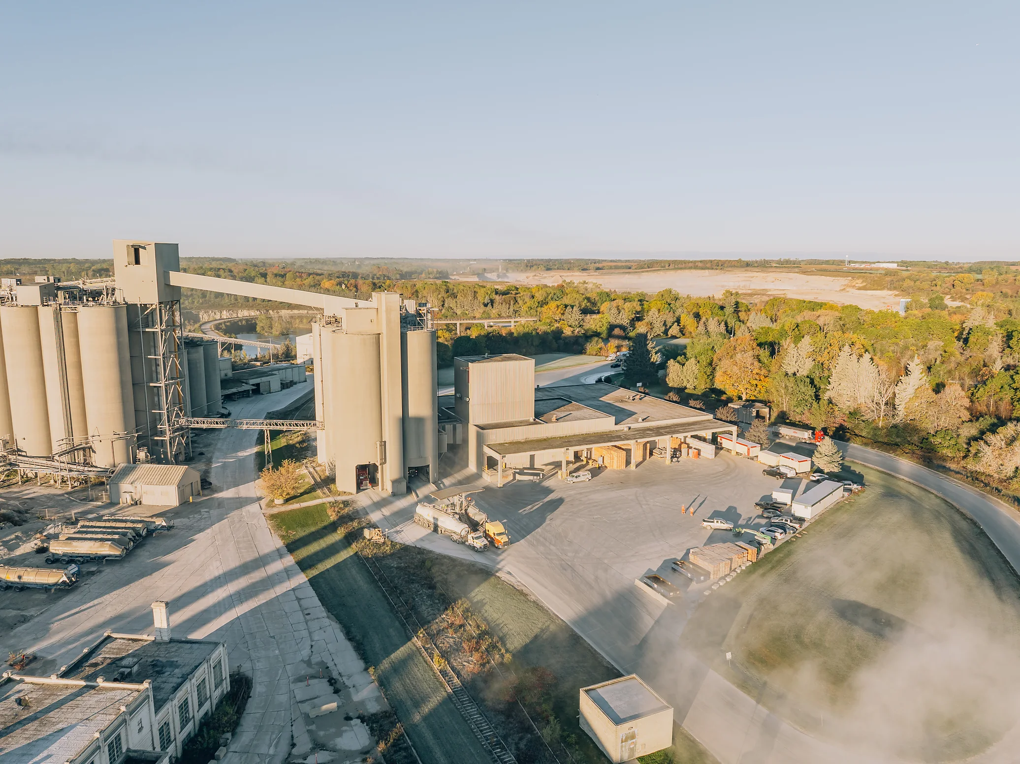 Type IS Cement - aerial view of cement silos, plant buildings and a truck loading yard