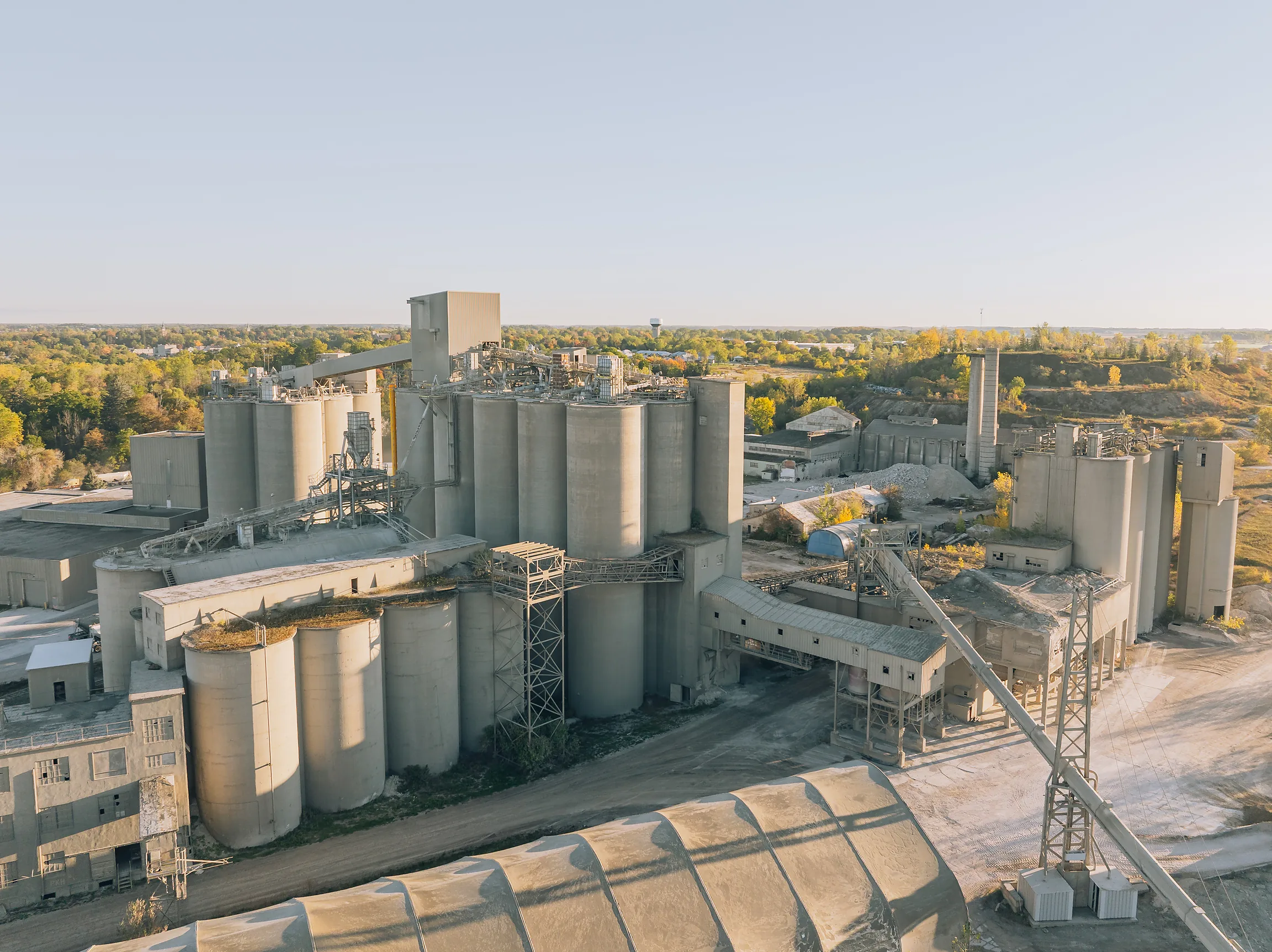 Cement Type IL(HE) - aerial view of the cement plant silo complex and conveyor gantries