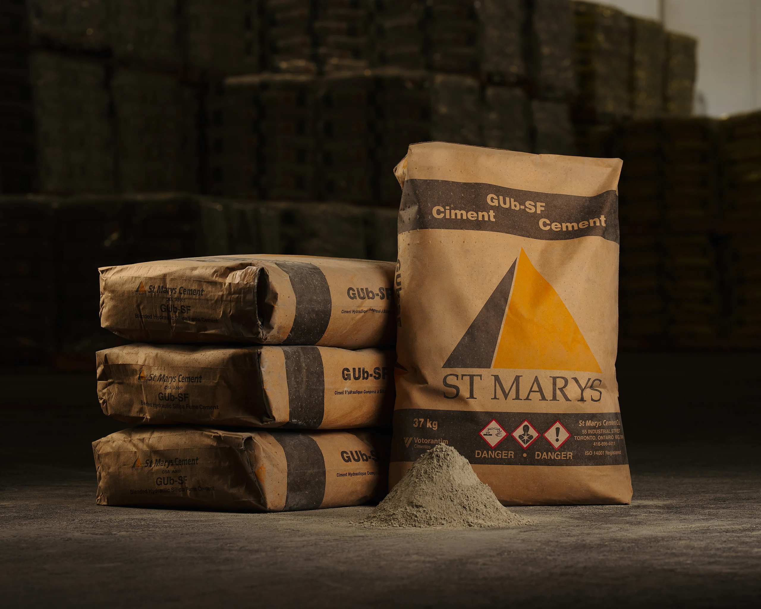 Blended Silica Fume Type GUb-SF Cement - kraft paper St Marys GUb-SF cement bags stacked beside a pile of cement powder