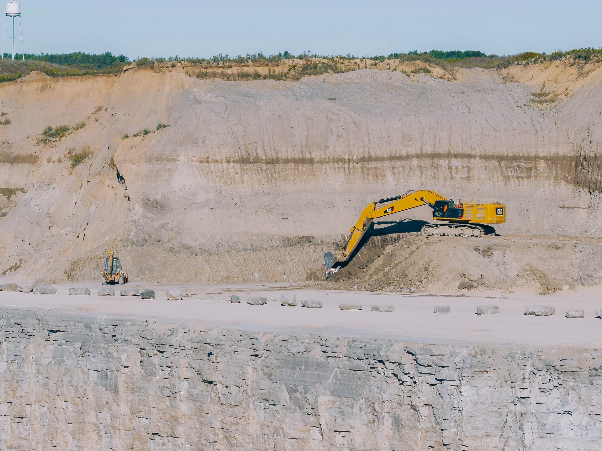 Type S Masonry Cement - excavator working on a bench of the limestone quarry wall