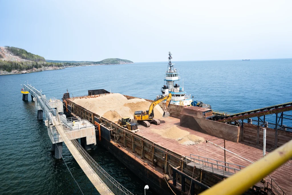 McInnis Community Relations - barge being loaded with material at the McInnis marine dock on the Gaspe coast