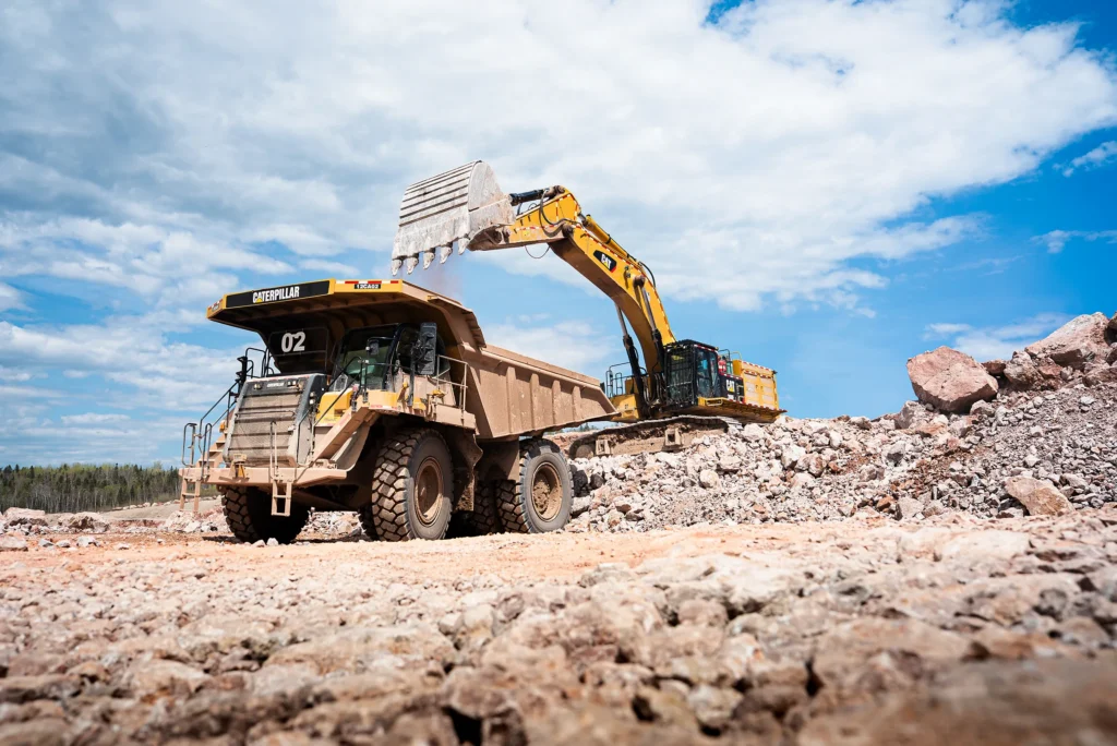 McInnis Community Relations - excavator loading a haul truck in the McInnis quarry
