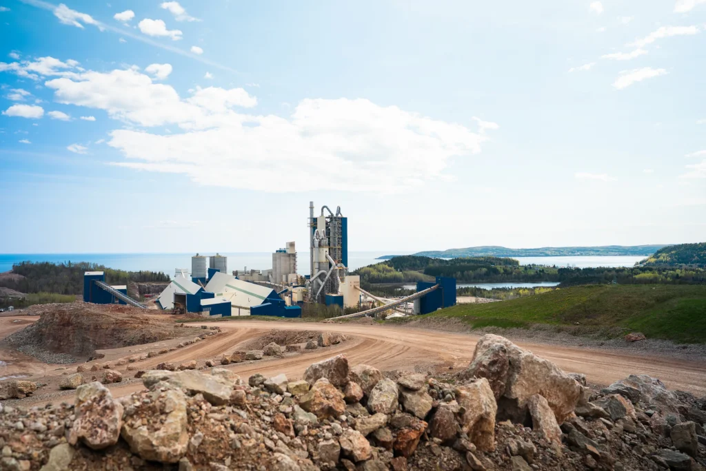 McInnis Community Relations - McInnis cement plant on the Gaspe coast seen across the quarry, with the sea behind