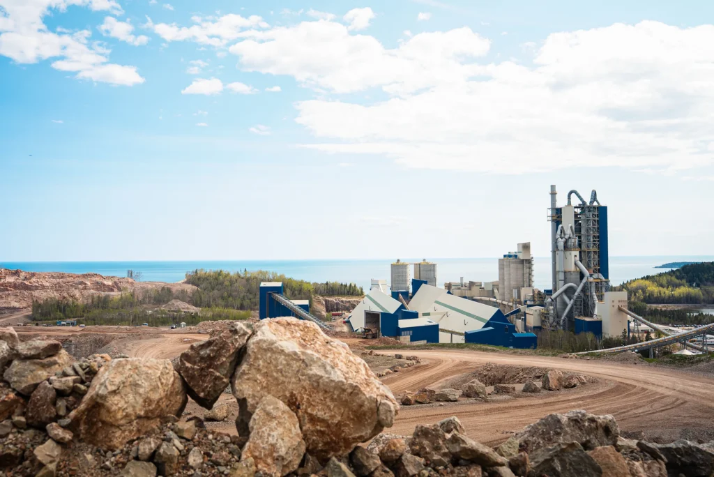 Plant Community Relations - cement plant seen from the quarry, with water on the horizon