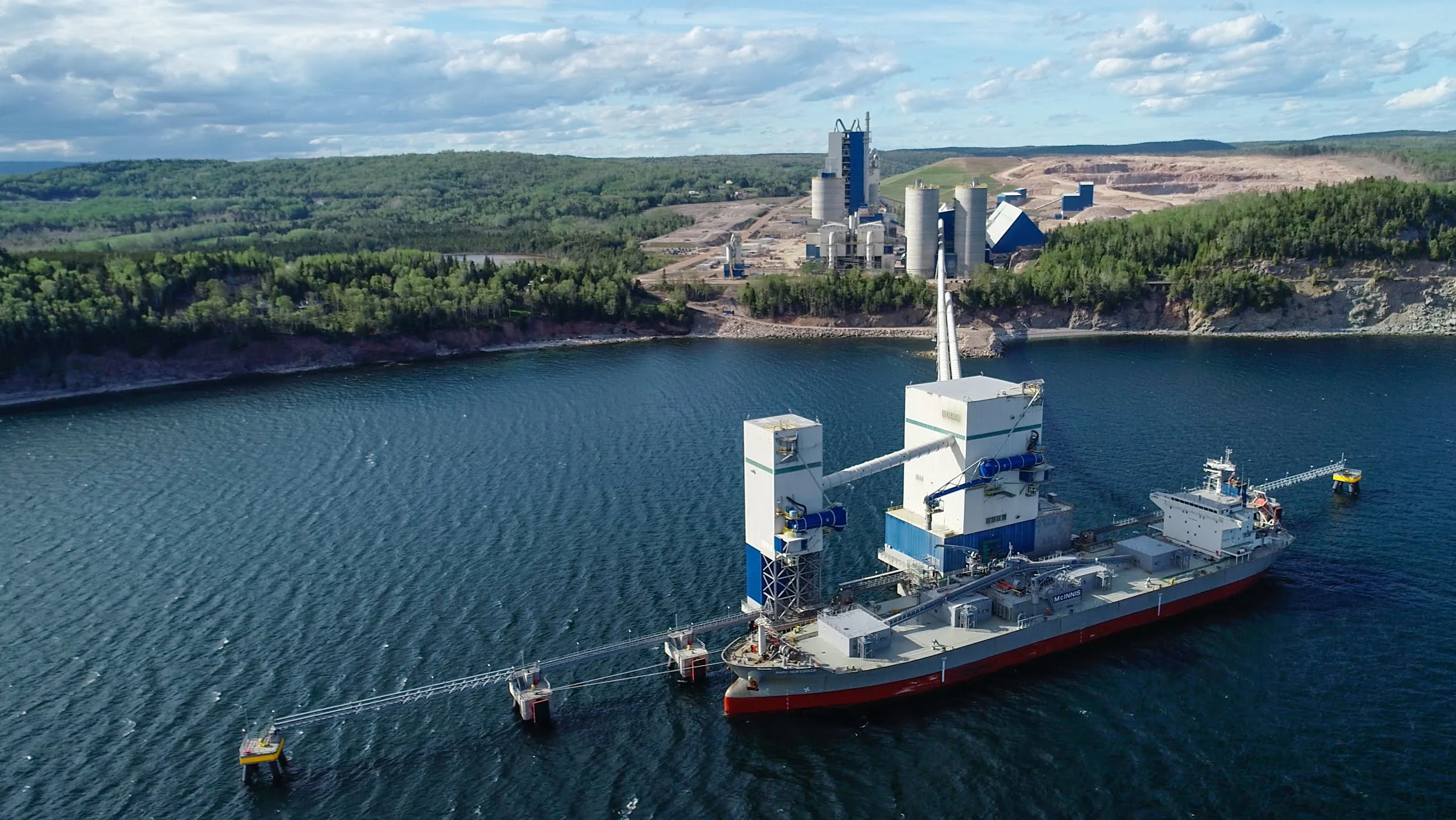 McInnis Cement Plant - ship loading at the McInnis dock, with the cement plant on the hillside behind