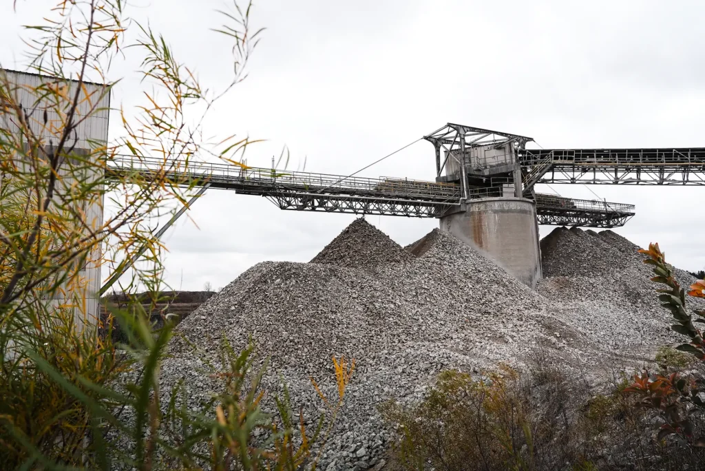 Plant Community Relations - crushed stone stockpiles beneath a conveyor at a St Marys Cement plant